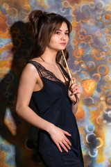 Obraz premium Young beautiful girl posing on the background of painted wall