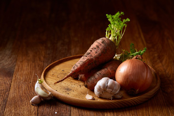 Artistically served vegetable salad with carrot, cucumber, letucce over wooden background,...