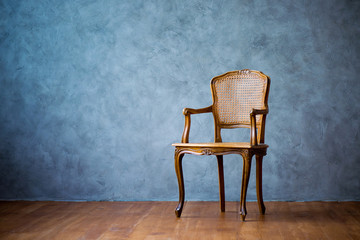 old chair on a gray wall background.