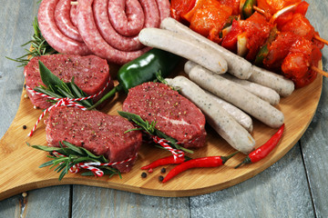 Selection of marinaded meat for bbq grilling with herbs on table