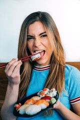 Crop woman eating sushi