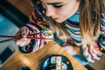 from above Crop woman eating sushi © DavidPrado