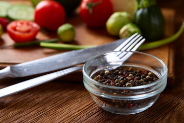 Fresh vegetable salad and ripe veggies on cutting board over wooden background, close up, selective focus