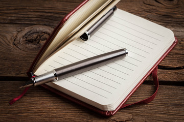 Blank notebook and ink pen.