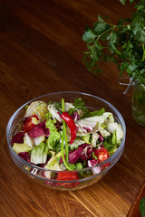 Fresh vegetable salad and ripe veggies on cutting board over wooden background, close up, selective focus