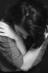 Folded hands of the woman as a symbol of loneliness and pain. (Body language, gestures, body psychology)