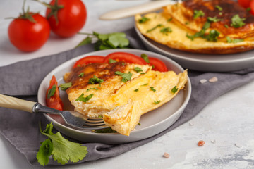 Delicious bright egg omelet with cheese and vegetables. Breakfast food concept, white background