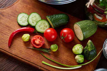 fresh vegetables on the cutting board over wooden background, selective focus, shallow depth of field