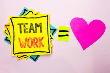Text sign showing Team Work. Conceptual photo Cooperation Together Group Work Achievement Unity Collaboration written on Stacked Sticky Note Papers on the plain background with Heart next to it.