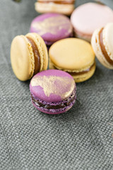 Close-up colorful French or Italian macaron on white wooden table. Macarons is French dessert served with tea or coffee. wallpaper, Vertical photo