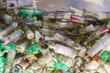 a large number of used with traces of paint cartridges for tattoo machines.