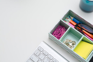 Top view of creative work space on white desk
