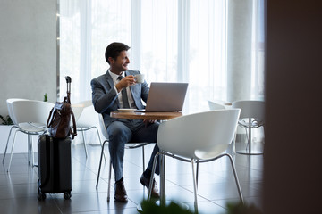 Businessman sitting in airport waiting area