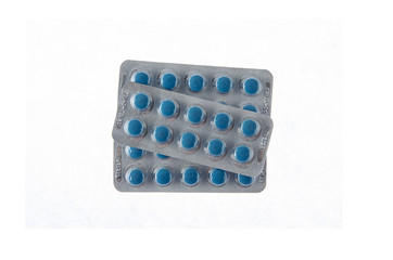 three plates of blue pills on white isolated background