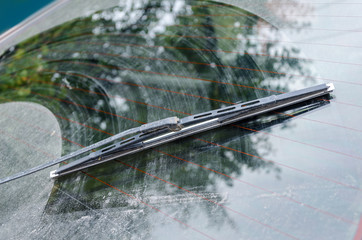 Dirty car window with a wiper blade - obrazy, fototapety, plakaty