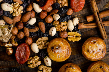 Nuts, dried fruits, pistachios and homemade cookies are scattered from the bag on the table