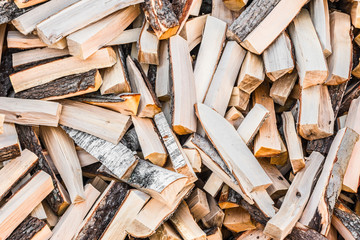 chaotically arranged in a pile of fresh chopped firewood, abstract background