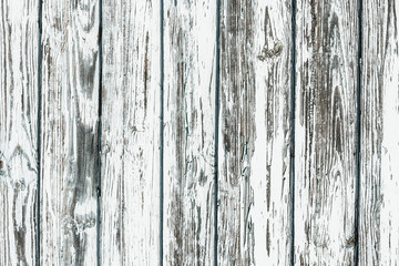 White wooden desk. Peeling paint grunge weathered wall background.