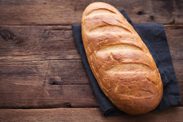 Fresh bread on wooden table. Top view with space for your text