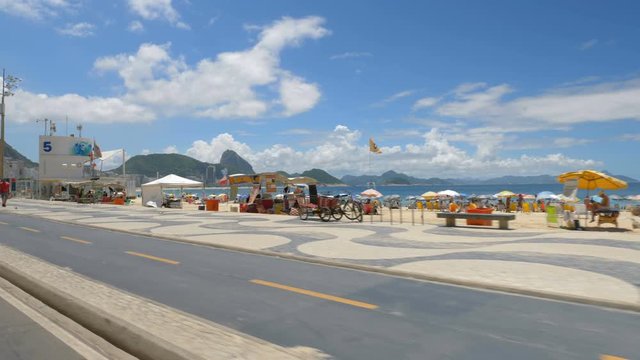 Driving along the famous Copacabana mosaic walkway. Slow motion. Rio de Janeiro, Brazil