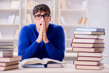 Male student preparing for exams in college library