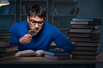 Student preparing for exams late at night in library