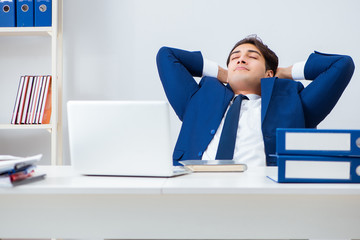 Young handsome businessman employee working in office at desk