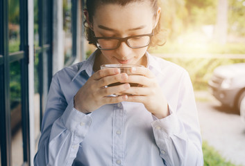 Portrait of young mixed race women holding a cup of drink.