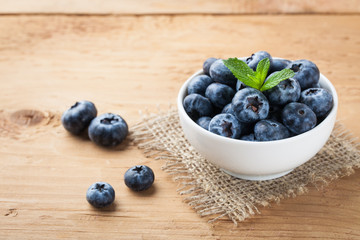 Blueberry on wooden table background. Ripe and juicy fresh picked blueberries closeup. Berries closeup with copy space