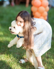 A beautiful girl is playing with a dog.