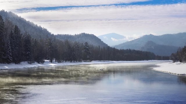 Mist above the Snowy Mountain River in Winter Morning. Altay, Siberia.