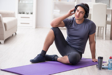 Man doing sports at home and listening to music