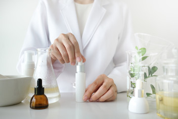 the scientist,dermatologist make the organic natural herb cosmetic product in the laboratory. beauty healthy skincare concept. herb medicine ,blank package,bottle,container.cream,serum.