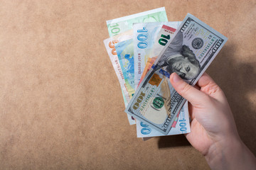 Hand holding American dollar  isolated on wooden background