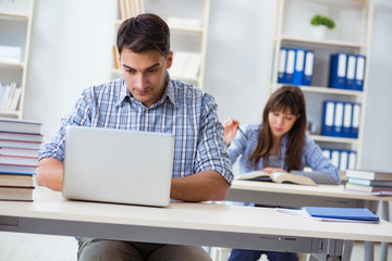 Students sitting and studying in classroom college