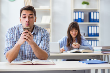 Students sitting and studying in classroom college