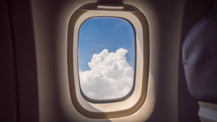 Clouds and sky as seen through window of an aircraft