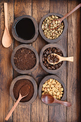 Close up of coffee beans and ground coffee in wooden bowl