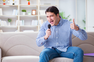 Funny man singing songs in karaoke at home