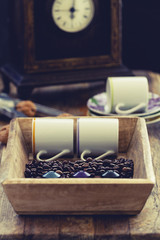 Coffee beans with italian espresso coffee capsules or coffee pods and espresso cups and  on a rustic wood background. Coffee accessories composition