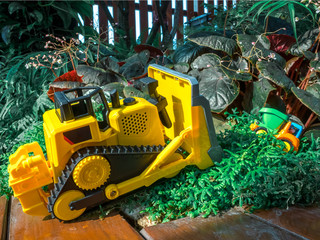 children baby toys tractor and truck on wooden floor in the beautiful garden forest playground