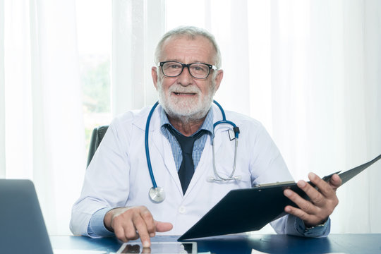 Senior doctor used tablet for checking patient profile