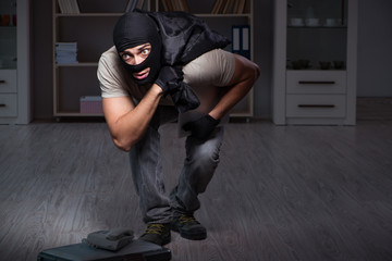 Burglar wearing balaclava mask at crime scene