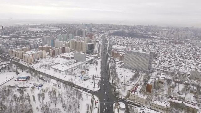 aerial panorama of snowy city, camera is showing a tv tower
