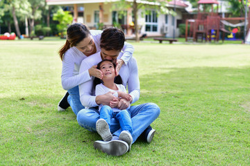 Fototapeta premium Happy male and female playing with children outside
