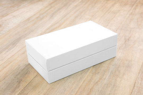 Empty white box mock up for product design on wood background