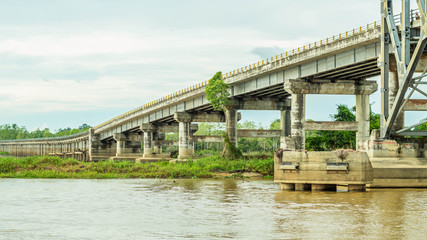 long concrete bridge foundation across swamp / peat land in Borneo, Indonesia