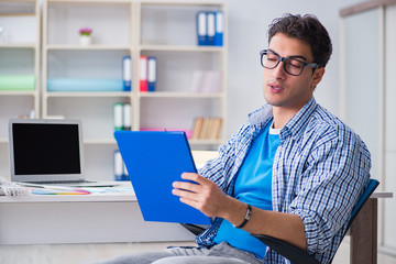 Young designer working on new project and choosing colours