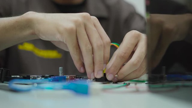 Students in Asian workshop uniform using iot development kit for educational science experiment