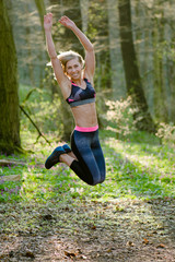 Sporty woman jumping outdoor. Successful active woman.